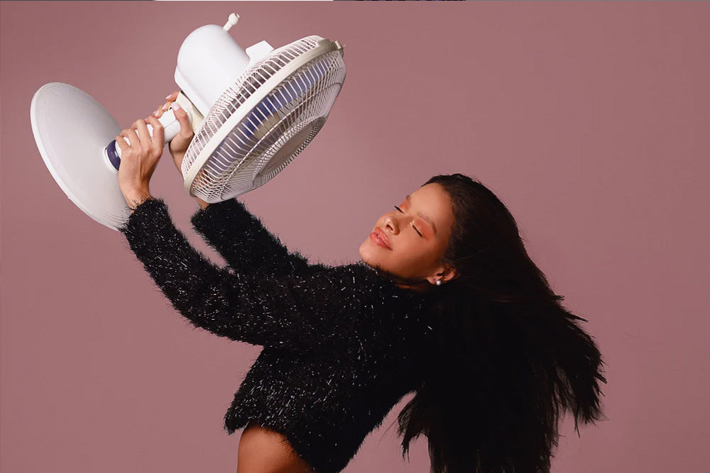 Fan Blowing Cool Air to Woman